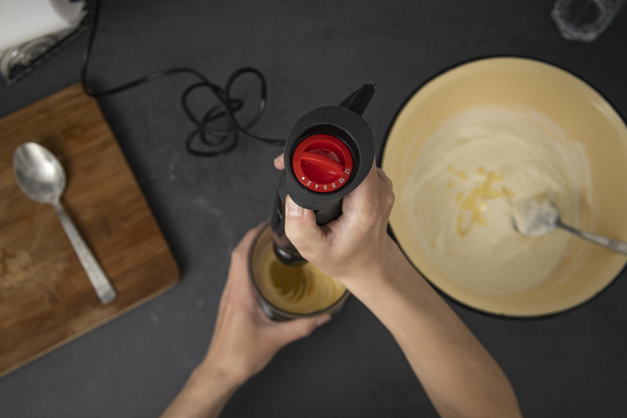 chef refining sauce in small jar